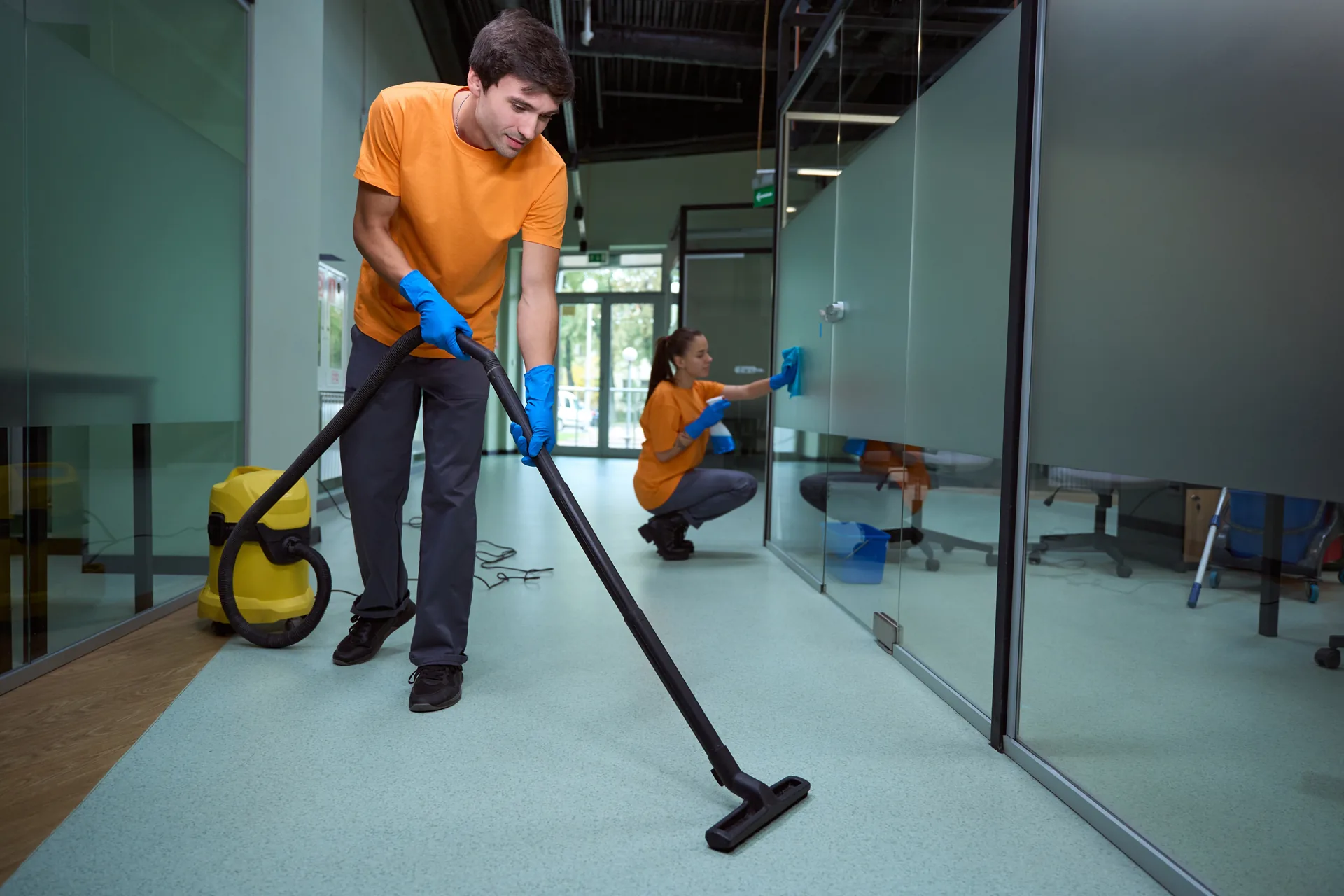 Commercial cleaner vacuuming an open-plan office floor