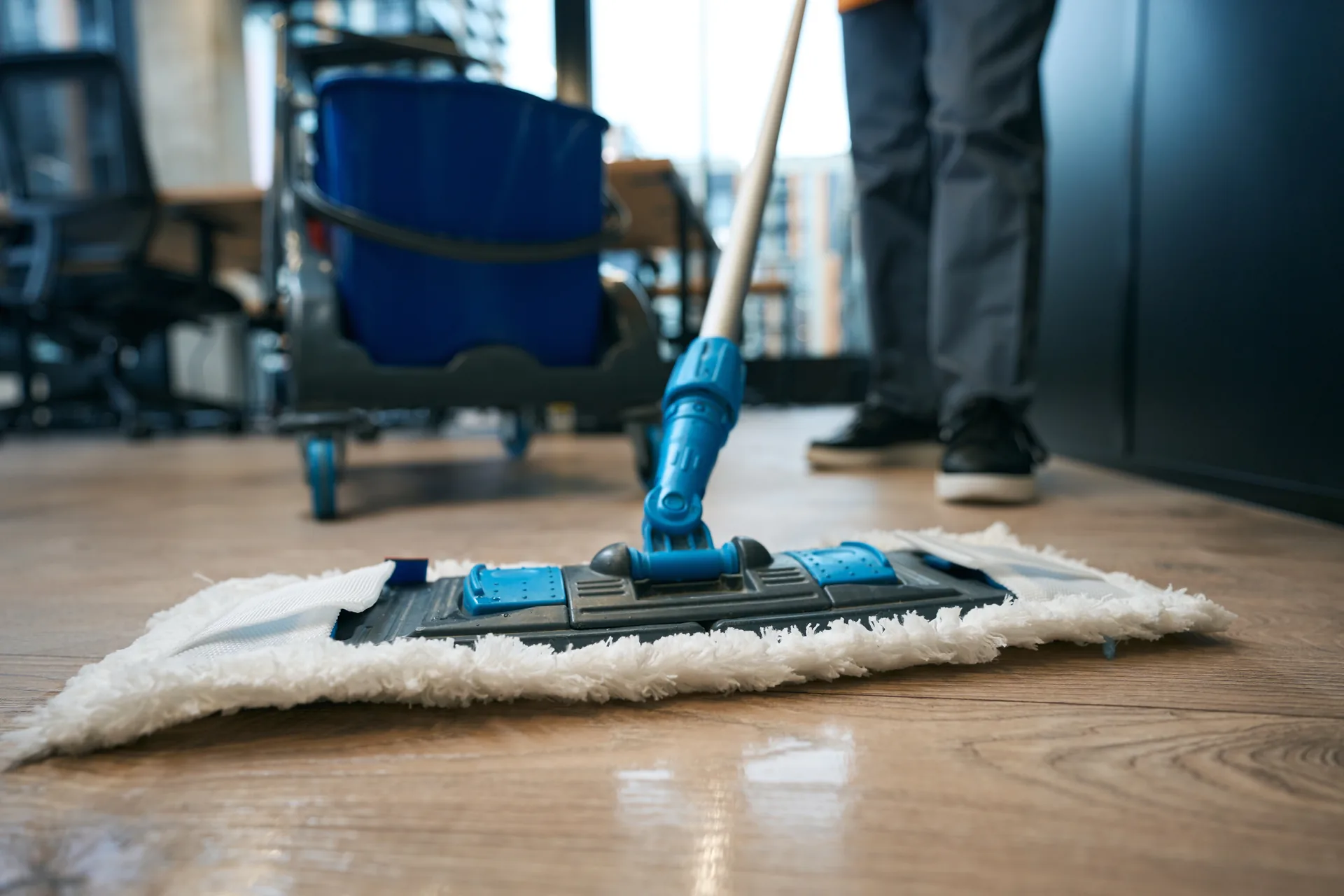Cleaner mopping a commercial office floor after hours