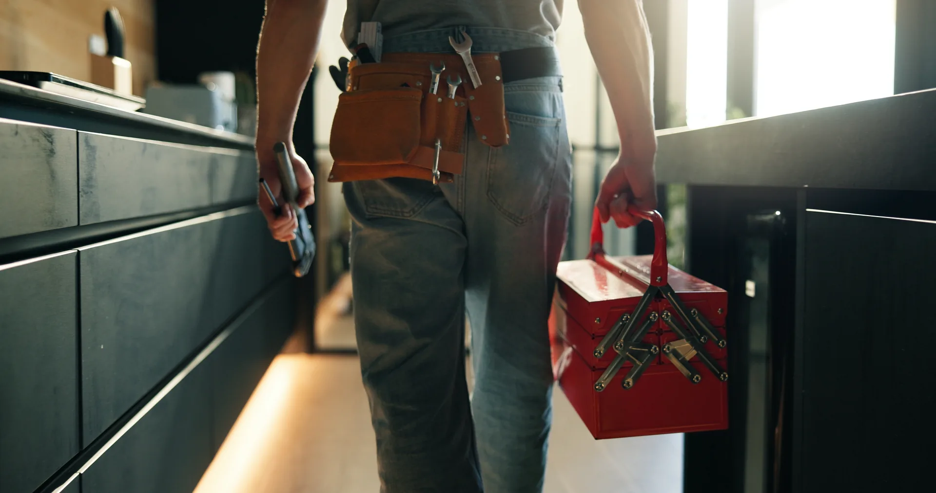 Tradesperson on site with toolbox ready to attend maintenance work