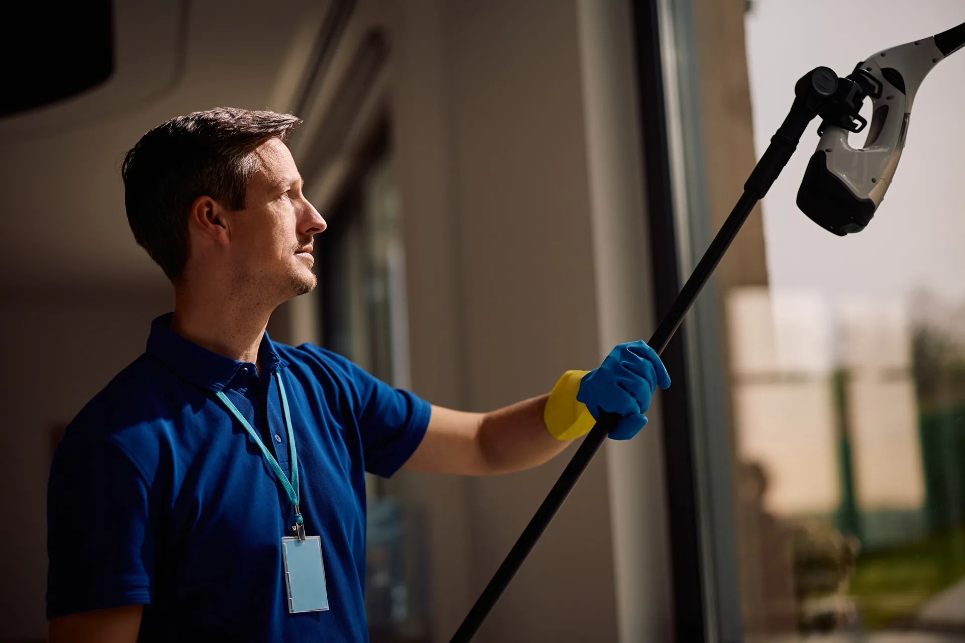 Squeegee finishing a commercial glass panel
