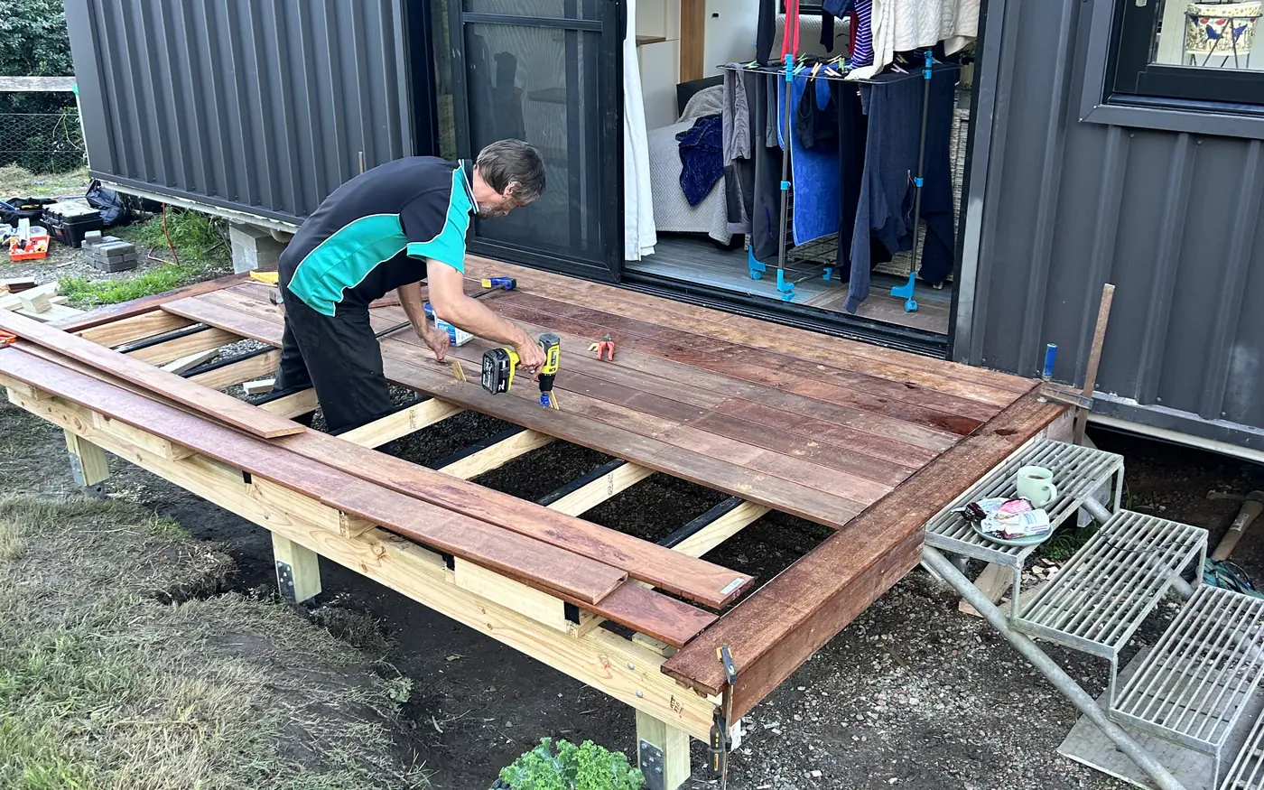 Universal Facilities Management tradesperson fixing timber decking boards on site